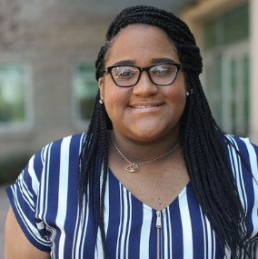 A person wearing glasses and a striped shirt